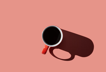 Top view of a cup of coffee on pink  pastel background