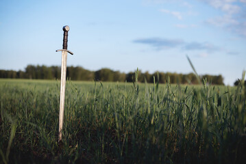 The ancient sword stuck in the ground background.