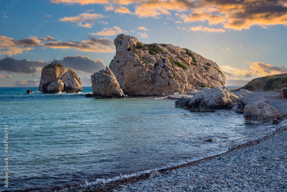 Wall mural Cyprus beaches. Rock Aphrodite. Sunset over cliffs of Cyprus. Beach near Paphos town. Sunset over stone of aphrodite. Cyprus on summer evening. Mediterranean coast. Evening landscape of Aphrodite