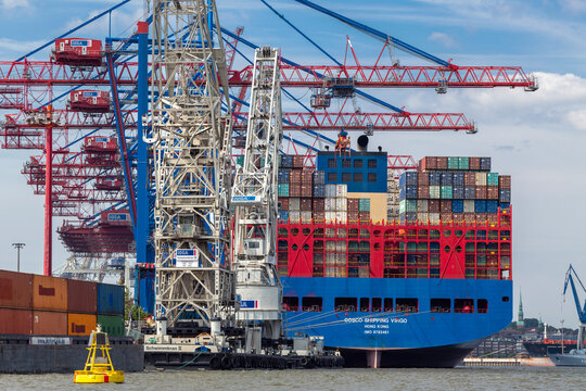 Hamburg, Germany - July 27, 2019: The container ship Virgo of the COSCO shipping line is loaded at the HHLA facility in the port.