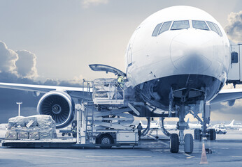 loading cargo on airplane, picture in a blue toning