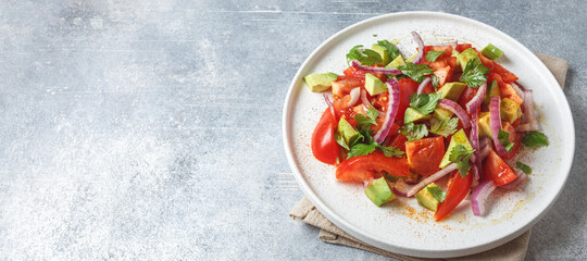Fresh salad with avocado, tomato and purple onion with space for text