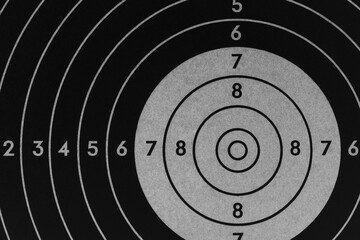 Target for shooting. Dark black and gray inverted background or wallpaper. Backdrop for shooting sports and training