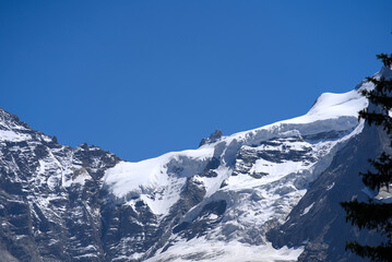 Jungfraujoch with research station Sphinx at Bernese highland on a sunny summer day with blue sky background. Photo taken July 20th, 2021, Lauterbrunnen, Switzerland.