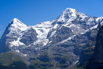 Obraz premium Peak Mönch (Monk) at Bernese highland on a sunny summer day with blue sky background. Photo taken July 20th, 2021, Lauterbrunnen, Switzerland.