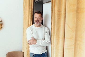 Trendy fit casual middle-aged guy standing with folded arms