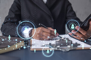 African American businesswoman signing the contract to boost her career and gain new opportunities in personal growth. Checking the detail of the deal at smartphone. Social media hologram icons