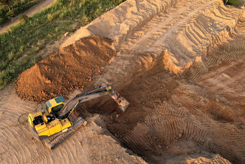 Excavator dig ground at construction site. Foundation pit for a multi-story building. Earth-moving...