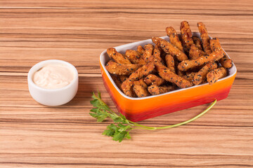 fried chicken on orange platter on wooden background