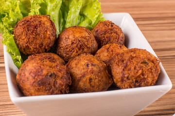 portion of dried meat dumpling on wooden background