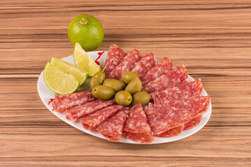 portion of salami on wooden background
