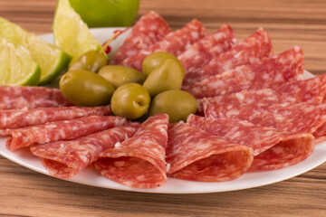 portion of salami on wooden background