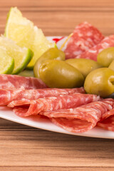 portion of salami on wooden background