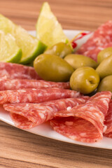 portion of salami on wooden background