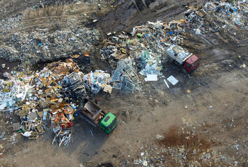 Arial view of garbage truck during unloading the сonstruction waste. Recycling debris. Work at...