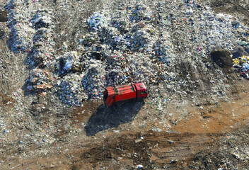 Garbage dump with food waste. Arial view of garbage truck unloads rubbish in landfill. Plastic rubbish dump. Reduce greenhouse gas emissions and methane emissions. Environmental protection