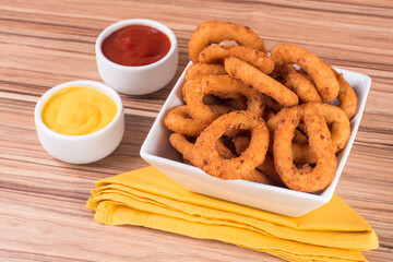 portion of onion rings on wooden background