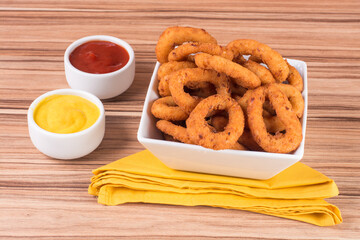 portion of onion rings on wooden background