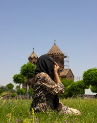 Faith of young religious woman wearing black hijab headscarf.