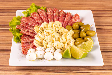 portion of cheese and salami on wooden background