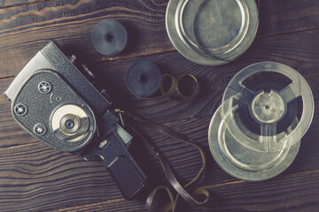 Old amateur movie camera, spools of roll film and reel of film stock