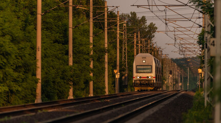 Plakat Trains and whistle stop Olesko in central Bohemia in sunset orange evening