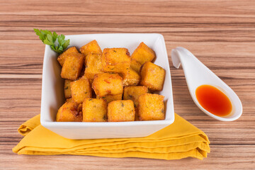 portion of fried polenta on wooden background