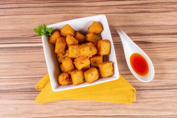portion of fried polenta on wooden background