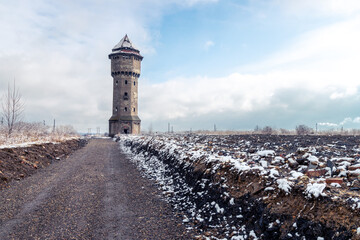 Winter view on an abandoned water tower in former Uthemann ironwork, Katowice, Silesia, Poland - obrazy, fototapety, plakaty