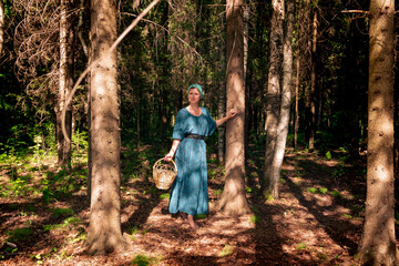 young woman in folk peasant clothes some with basket for picking wild plants, berries or mushrooms...