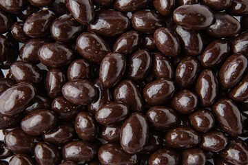 Candies. Almonds in dark chocolate. Desserts for candy bars. Little white dragees