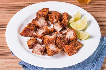 portion of pork cracklings on wooden background