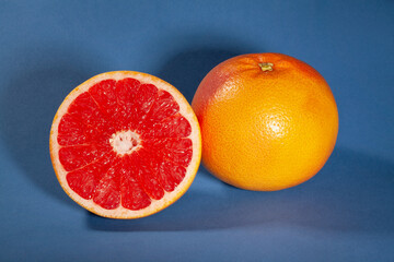 sliced grapefruit on blue background