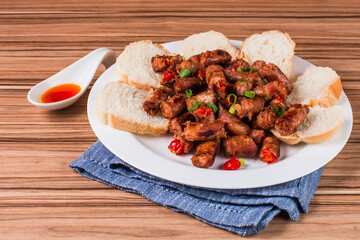 sausage portion with wood and brick background