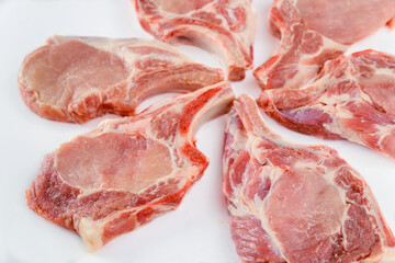 Raw pork chops bone in isoladet on white background.