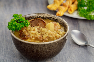Homemade soup with mushroom, barley and crakers.