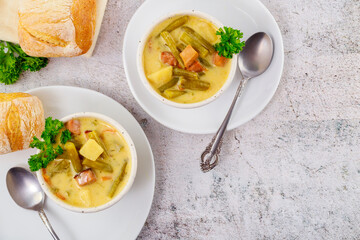 Homemade vegetable soup with cut green peas, potato and meat.