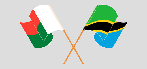 Crossed and waving flags of Madagascar and Tanzania