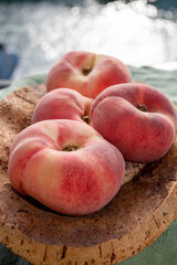 Fresh ripe flat peaches Prunus persica or doughnut peach or Saturn peach