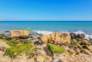 Atlantic coast with stones, sand and clear water.