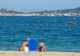 Undentified people sunbathing on sandy beach on French Riviera, Var, France