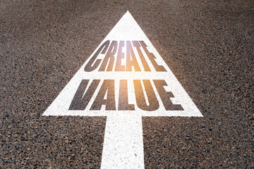 On the asphalt road markings an arrow with the inscription - CREATE VALUE
