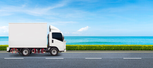 The semi-truck is driving on a two-way beach road. The concept of fast and environmentally friendly...