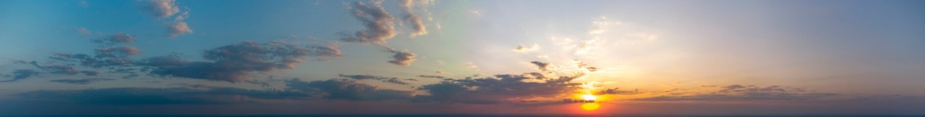 Panorama of orange sky with clouds. Sunset.