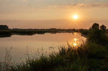 Colourful sunset over the ponds reflected in the water