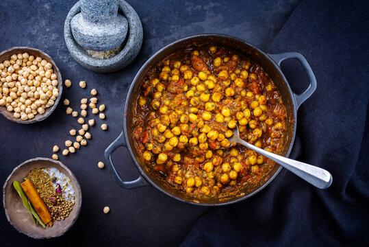 Traditional Indian chana masala curry stew with chickpeas and spices served as top view in saucepan