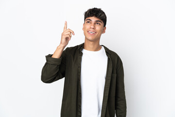 Young man over isolated white background intending to realizes the solution while lifting a finger up