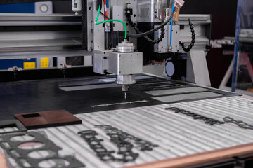 Automated cnc turning milling machine cutting sheet metal at factory, exhibition, plant. Metalworking, engraving, industrial, equipment, technology, manufacturing concept