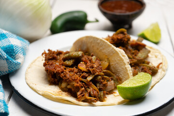 Mexican food. Chilorio and nopales tacos on white background
