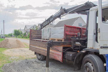 Loading a pallet with paving slabs on a truck.